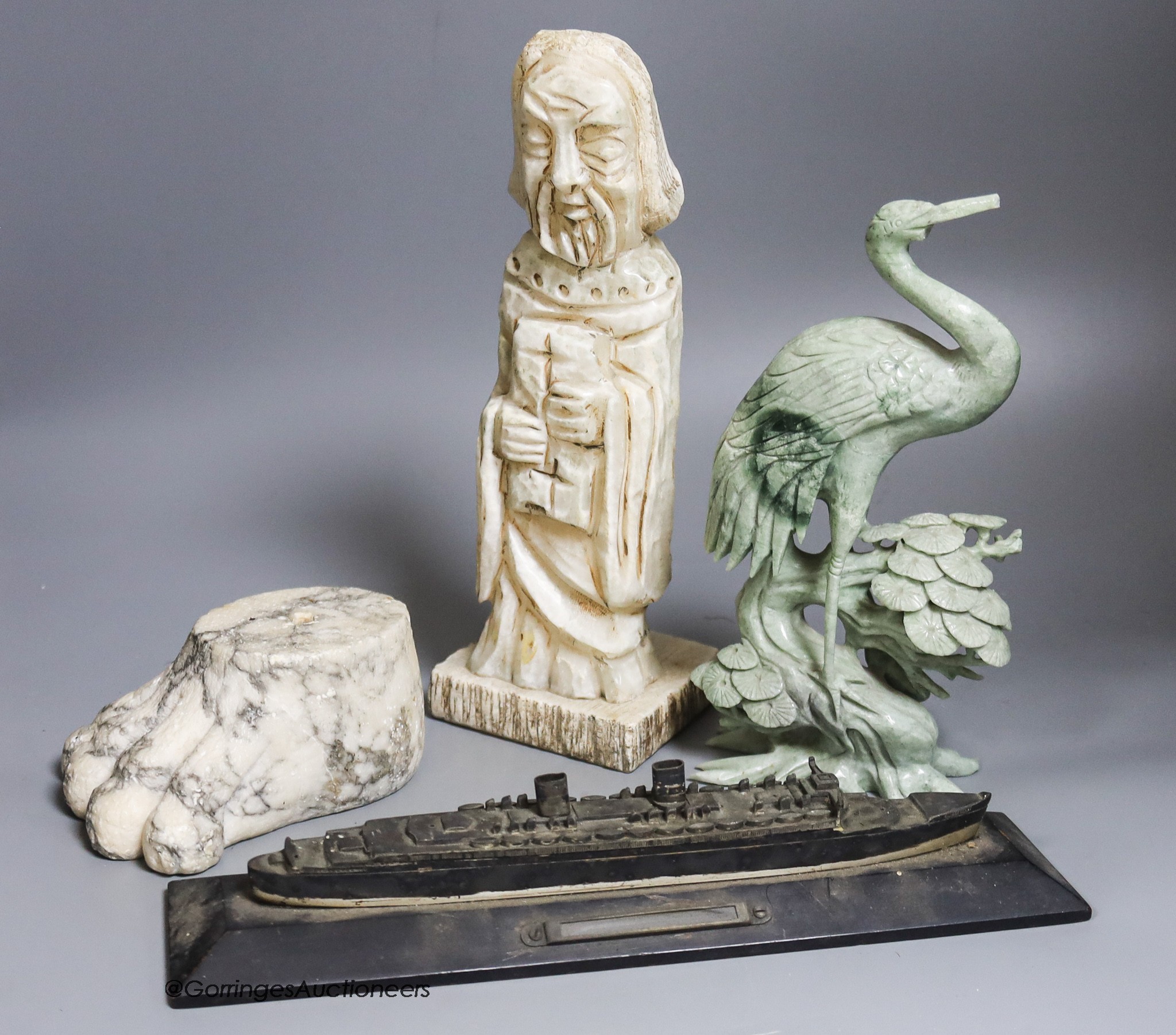 A large marble lion's paw, an alabaster monk, a soapstone crane and a white metal model of The Queen Mary ship